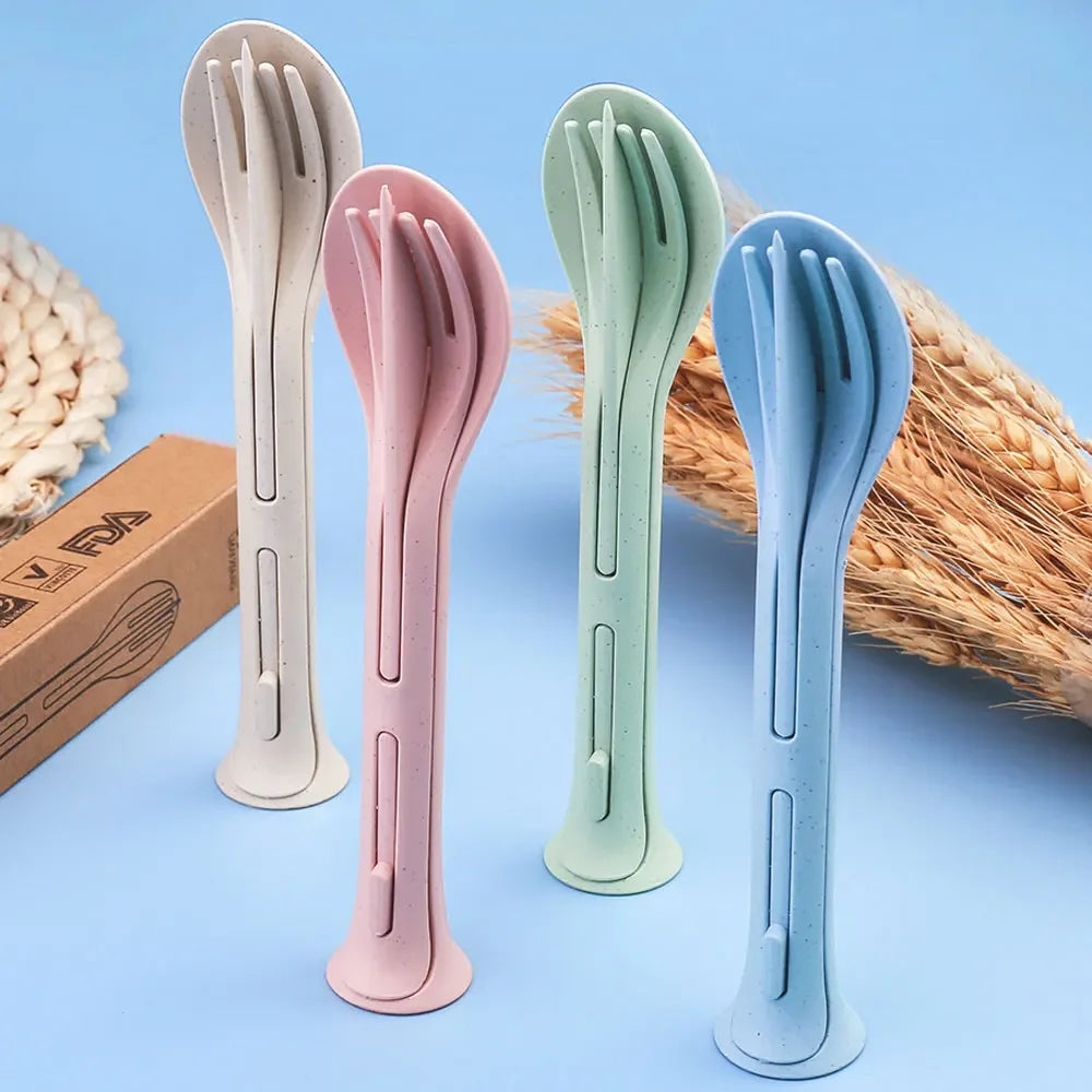 Set of four colorful plastic kawaii utensils on a blue background