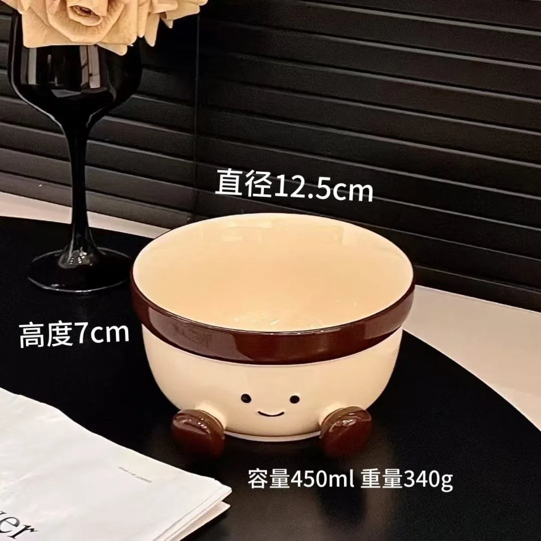 Ceramic kawaii bowl with smiley face design on a black surface, with text indicating dimensions and capacity.