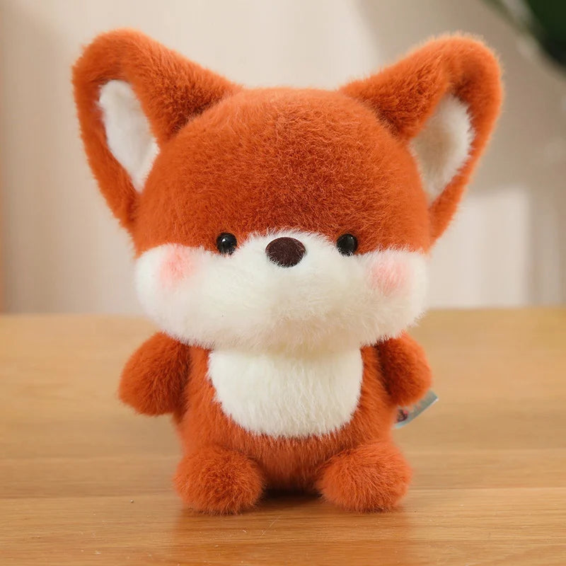 Plush kawaii toy fox on a wooden surface with a blurred background