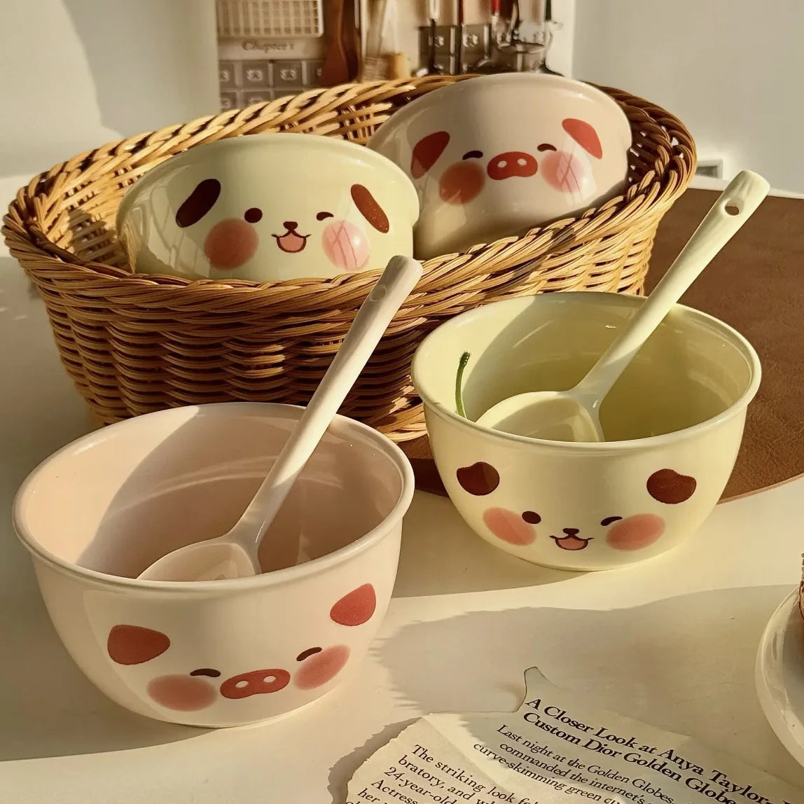 Ceramic kawaii ramen bowls with cartoon faces and spoons on a table