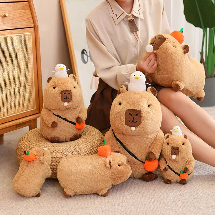 Person holding a collection of brown plush kawaii toys resembling animals on a light-colored floor.