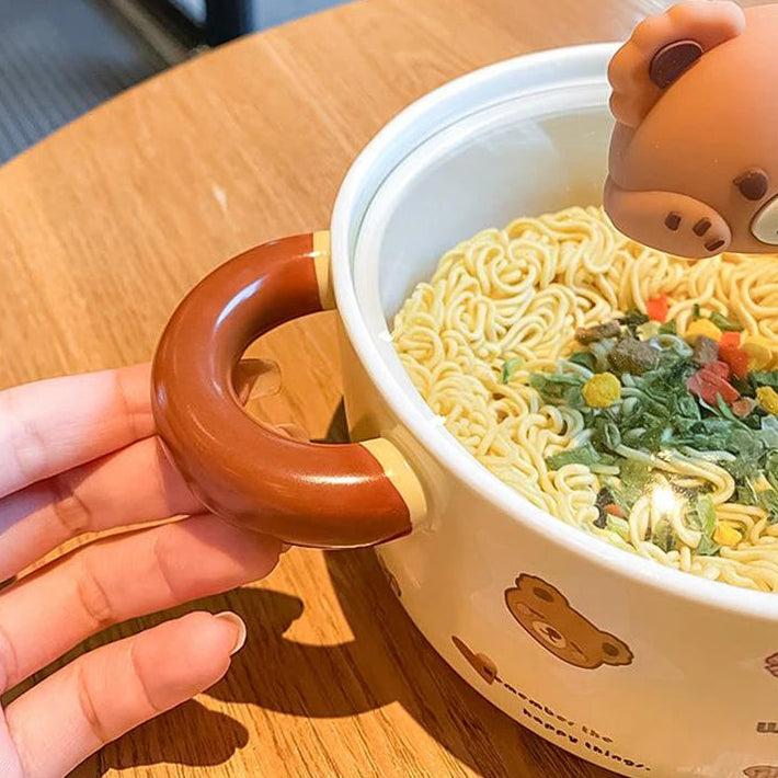 Close up of a hand holding a bear themed kawaii ramen bowl