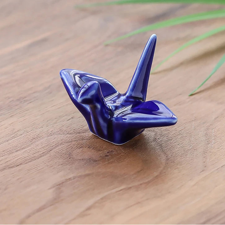 A dark blue kawaii chopstick holders on a table