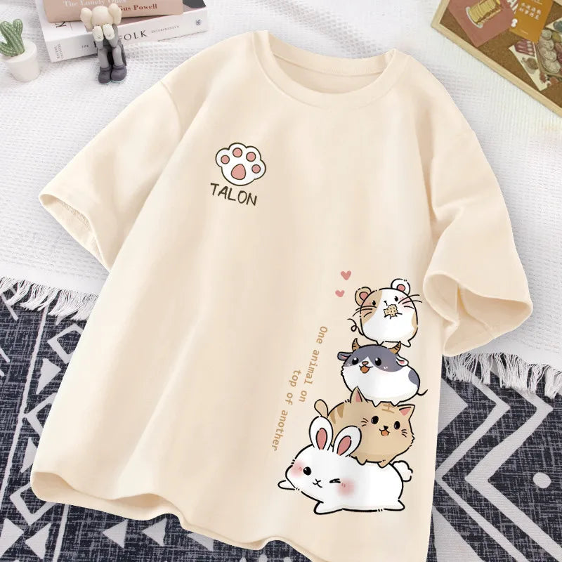 Beige t-shirt with kawaii cartoon animal designs and 'Talon' branding on a textured surface.