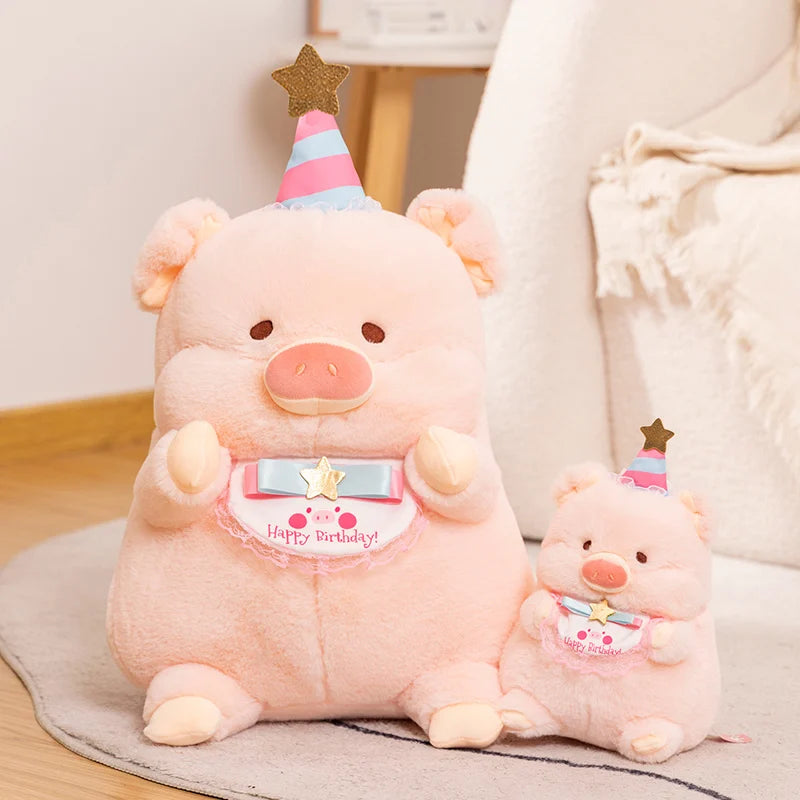 Two pink kawaii plush pigs with birthday hats on a light-colored surface.