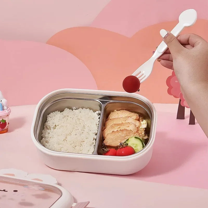 Kawaii bento box with compartments of rice and salad on a pink background