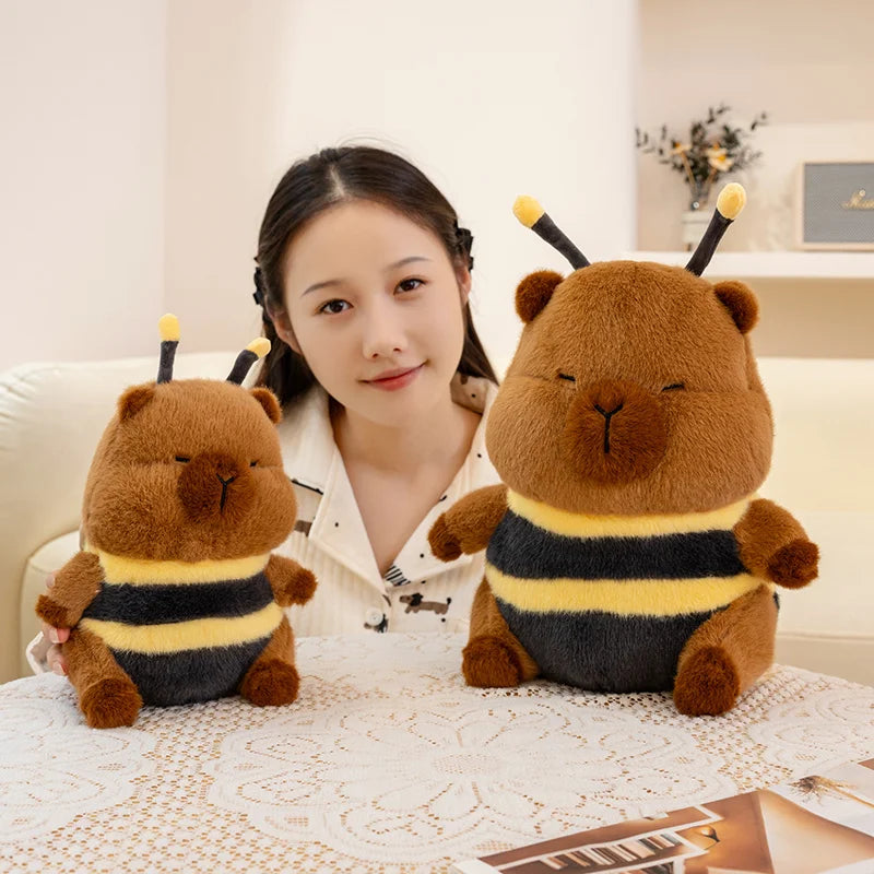 Woman sitting with two kawaii plush bee toys on a table
