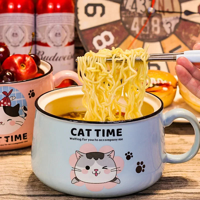 A blue kawaii ramen bowl with a cat time design on it