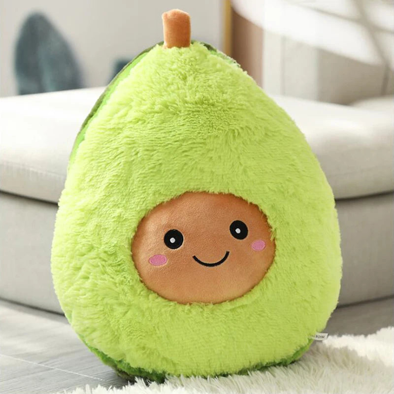 Kawaii plush avocado toy with a smiling face on a light-colored couch.