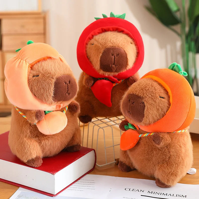 Three kawaii plush toys resembling bears in Halloween costumes on a table with books and papers.