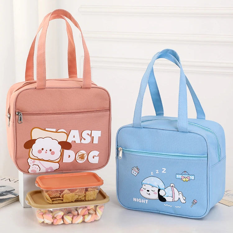 Two kawaii lunch bags, one pink and one blue, with cartoon characters on a white background.