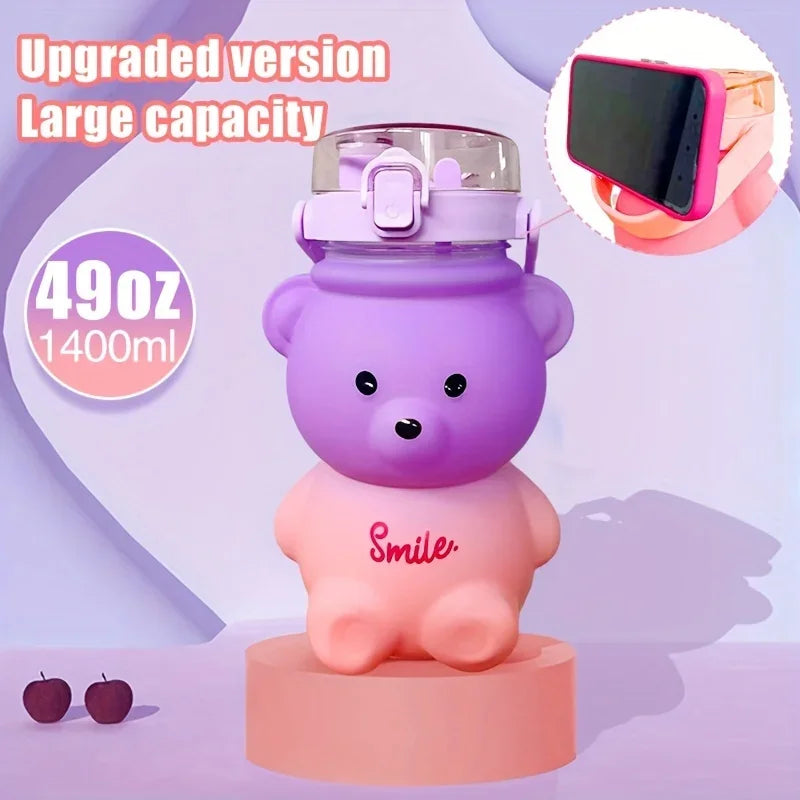 Purple and pink bear-shaped kawaii water bottle with a phone holder on a light purple background