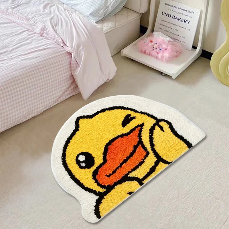 Yellow duck-shaped kawaii rug on a light-colored floor with a bed and chair in the background.