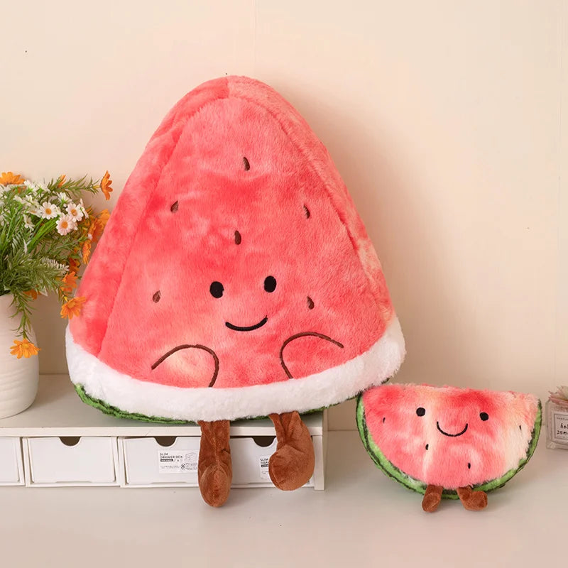 Kawaii plush watermelon toy with a smaller version on a shelf with decorative items.