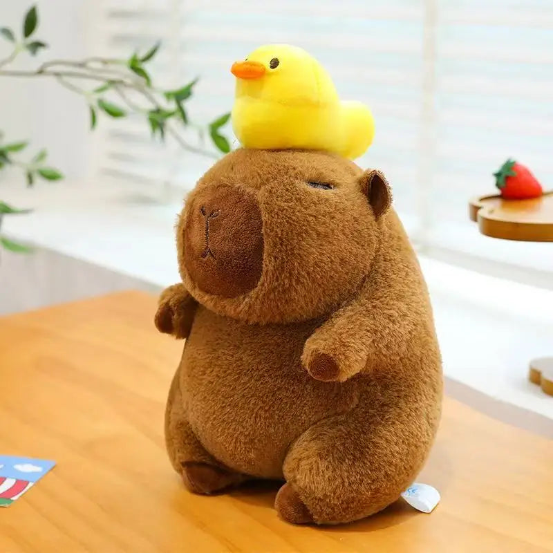 Kawaii plush toy groundhog with a yellow duck on its head on a wooden surface.