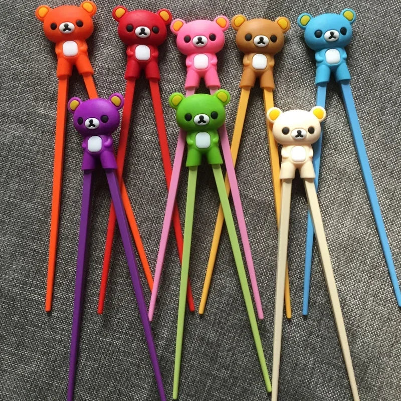 Set of colorful bear-shaped kawaii chopstick holders on a textured surface