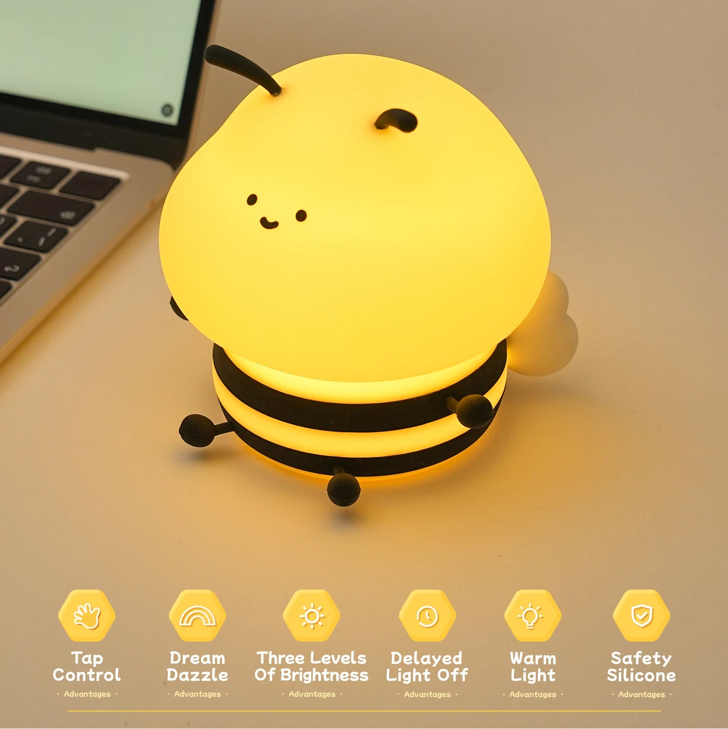 Yellow bee kawaii night light on a desk next to a laptop with product features listed below.