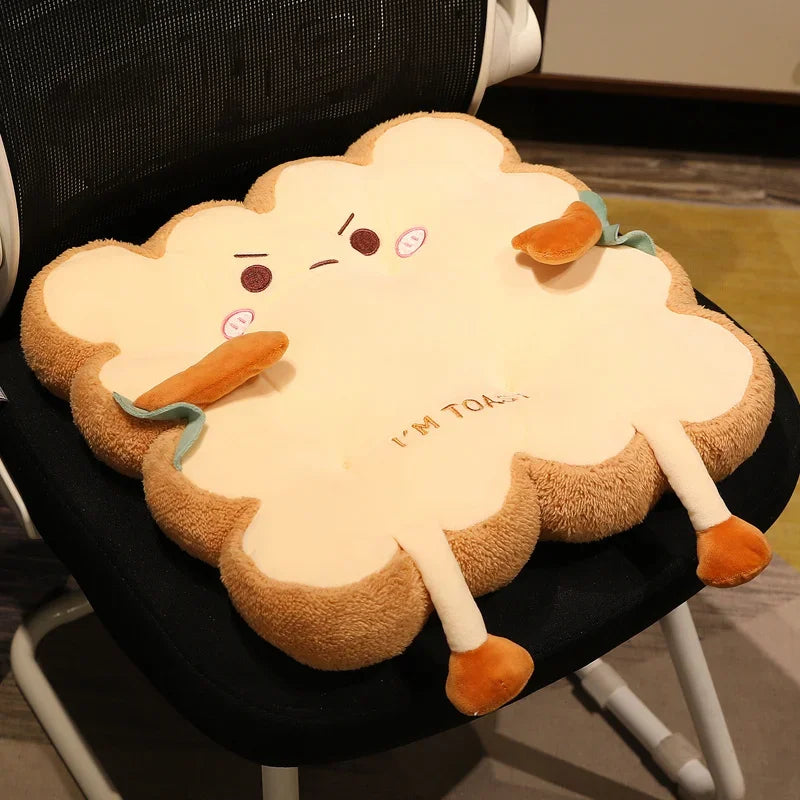 Kawaii plush cloud-shaped pillow with a face and text on a chair