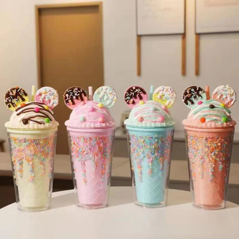 Four colorful kawaii cups with decorative toppings on a white surface.