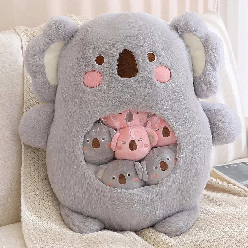 Kawaii plush toy shaped like a koala with a smaller koala inside on a couch.
