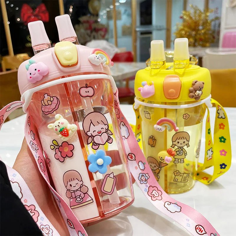 Two children's kawaii water bottles with cartoon designs on a table.