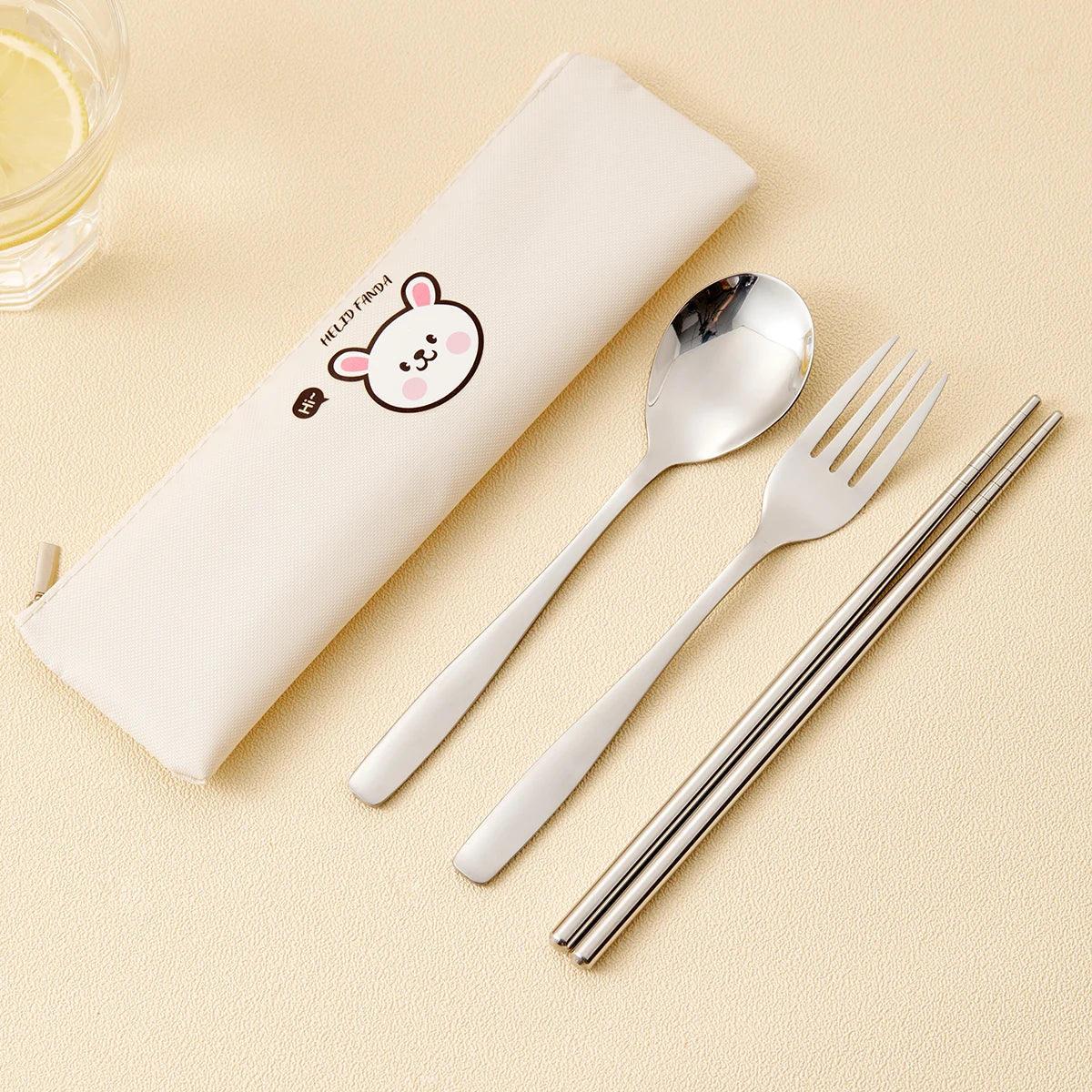 Stainless steel kawaii utensils set with a white case featuring a cartoon character on a beige background.