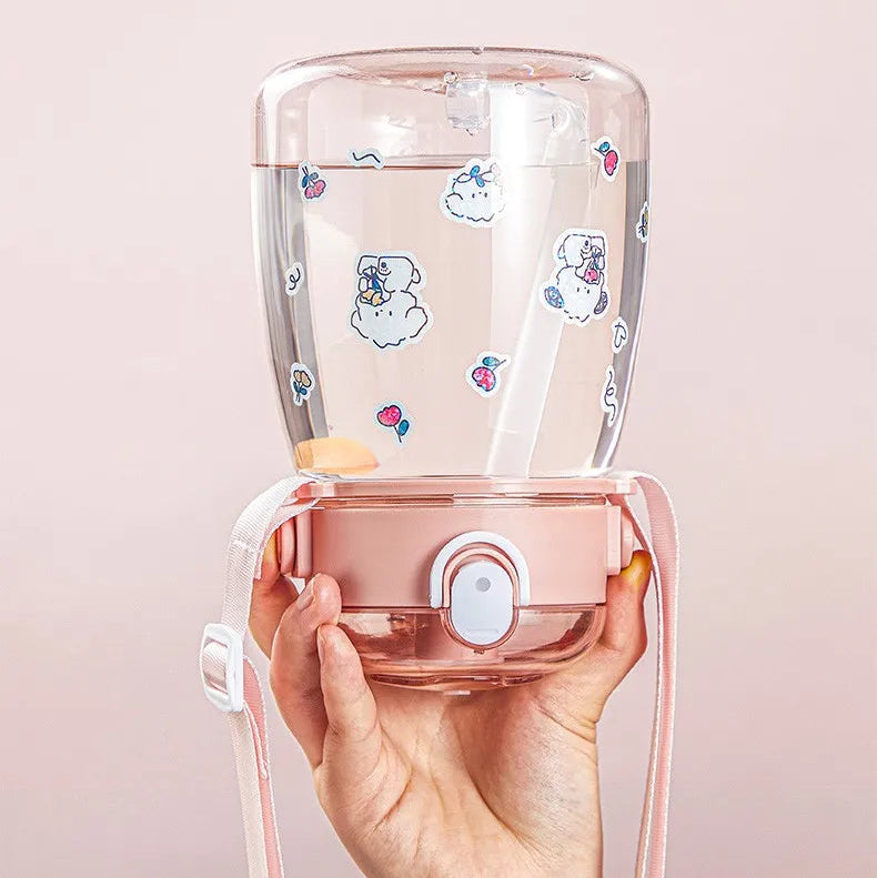 Hand holding a leak-proof kawaii travel mug with text highlighting its features on a light pink background