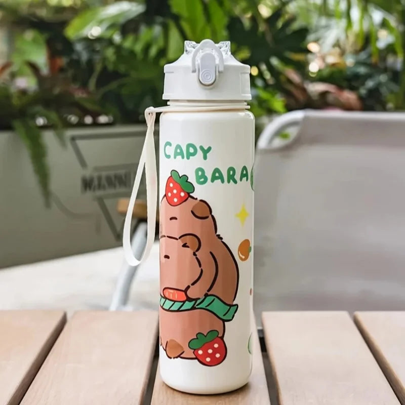 Capybara-themed kawaii water bottle on a wooden table with plants in the background