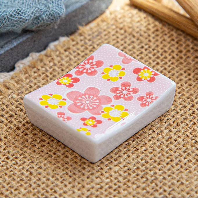A square shaped kawaii chopstick holders with a floral pattern