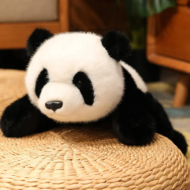 Kawaii plush panda toy lying on a woven surface with a blurred background
