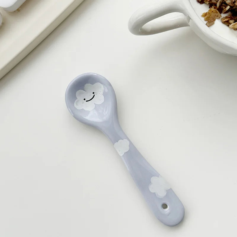 Kawaii spoon with cloud design on a white surface
