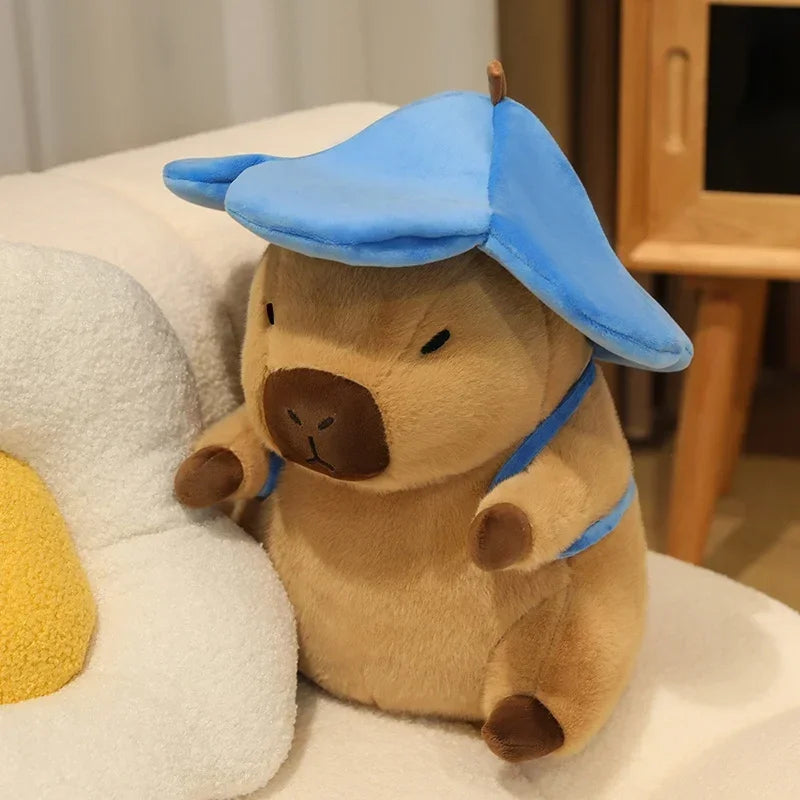 Kawaii plush toy resembling a bear with a blue hat on a white surface