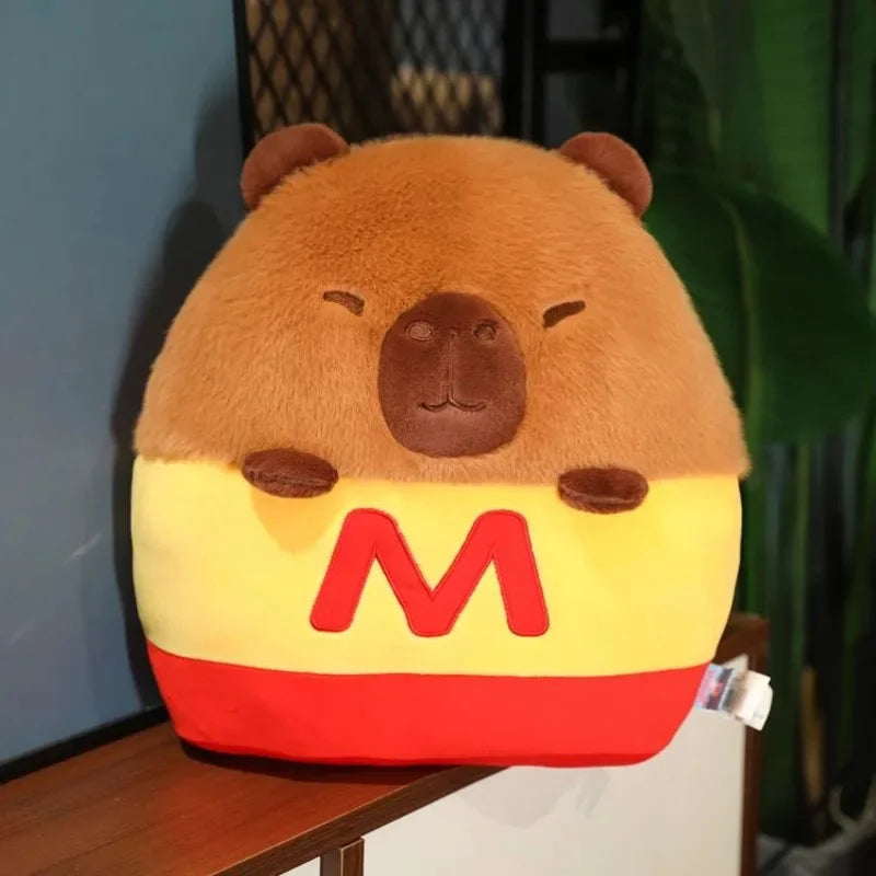 Kawaii plush toy bear with a yellow belly and red 'M' on a wooden surface.