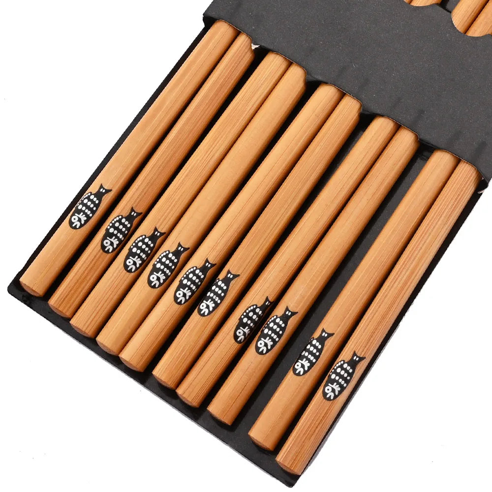 Set of wooden kawaii chopsticks with fish design on a black holder