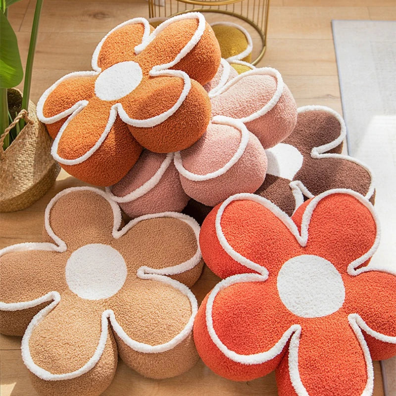 Flower-shaped kawaii cushions in various colors on a wooden surface