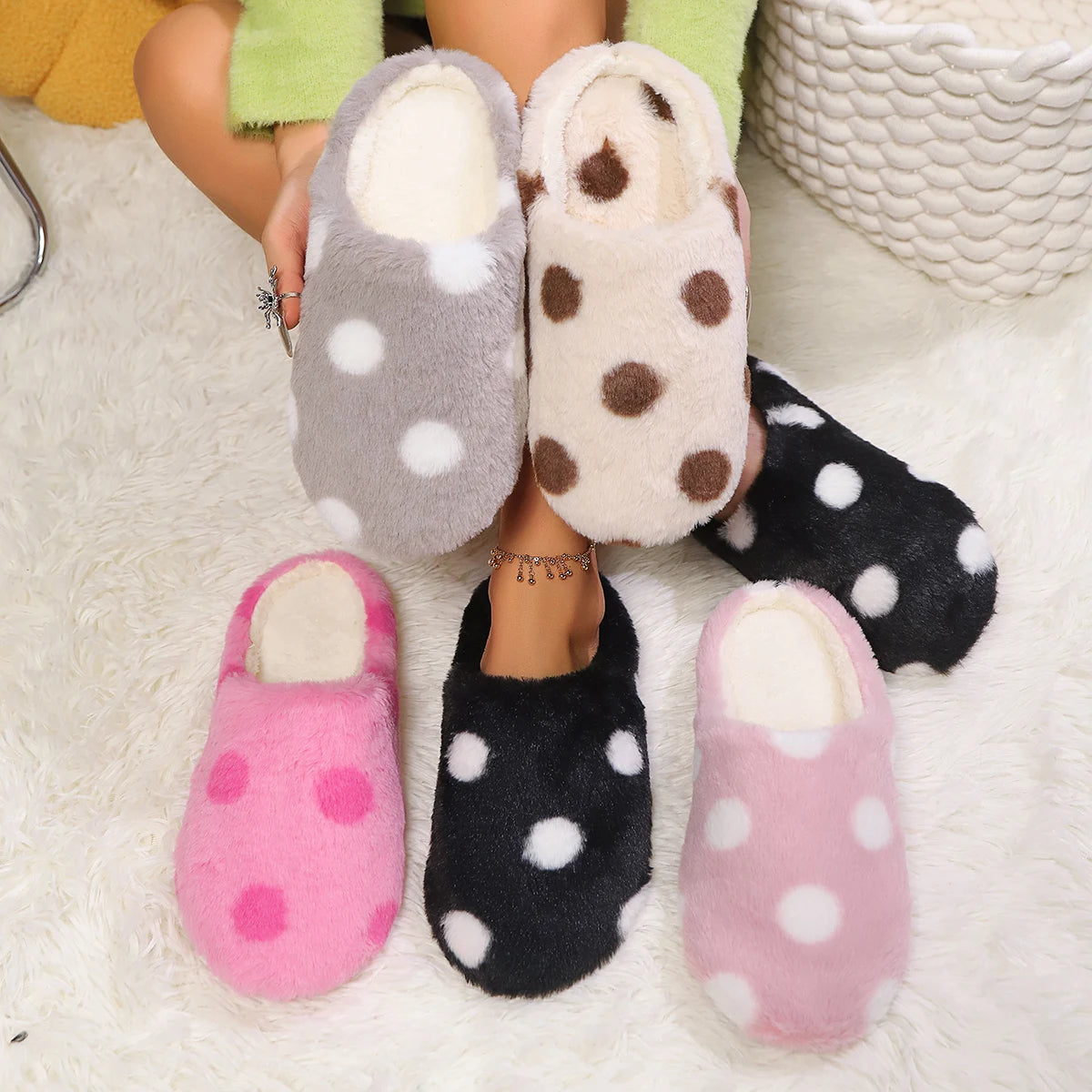 Polka dot kawaii slippers in various colors held by a person on a soft surface.