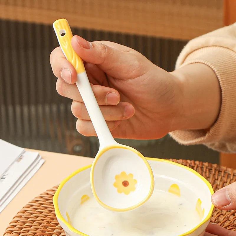 A person holding a white ceramic kawaii spoon
