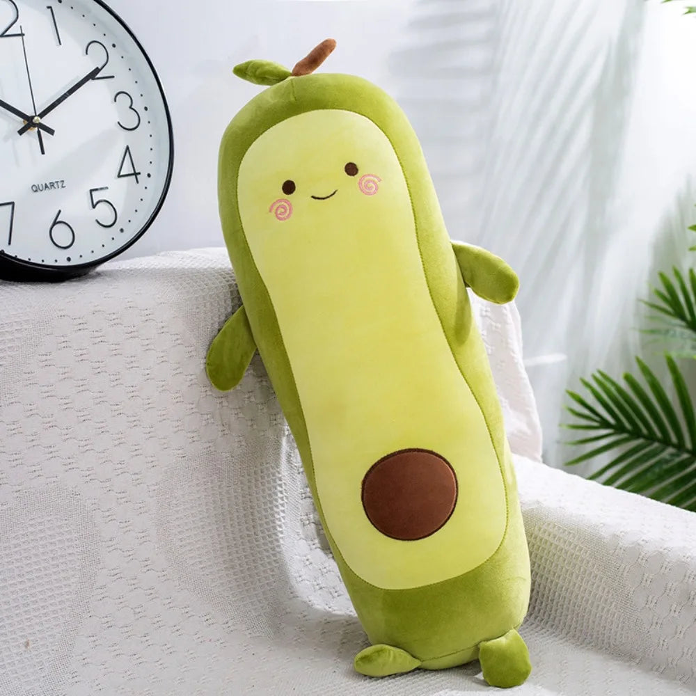 Kawaii plush avocado toy on a white surface with a clock in the background