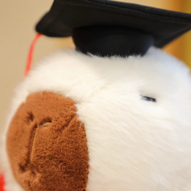 Close-up of a capybara plush toy with a brown patch on a beige background