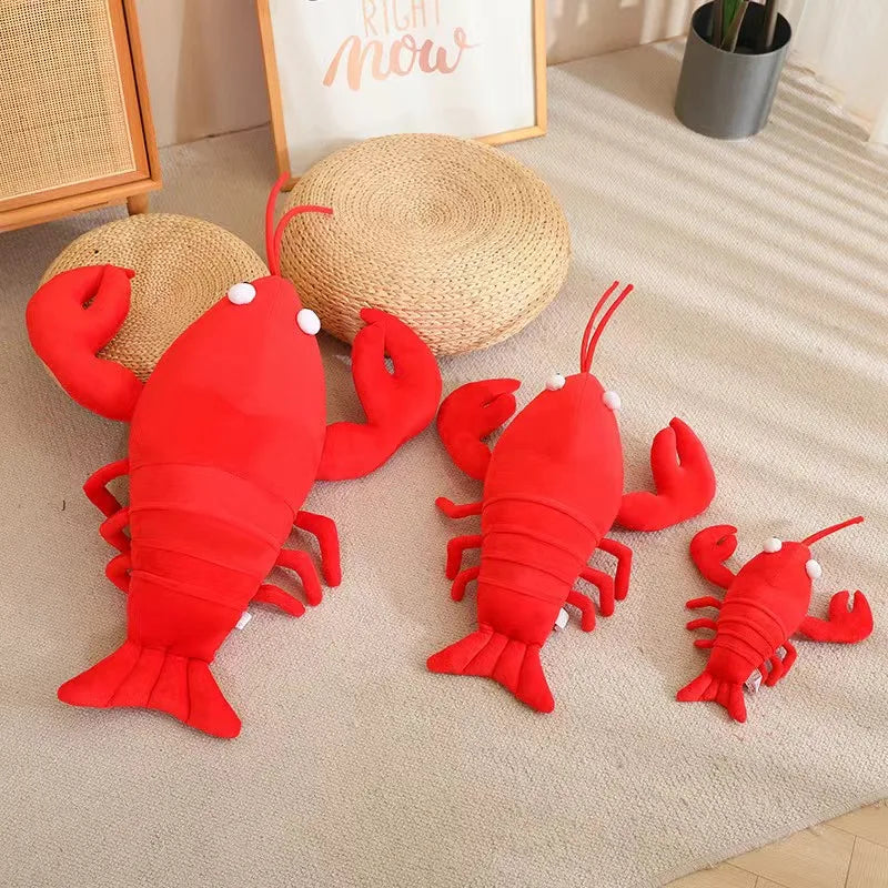 Three red lobster kawaii plush toys on a beige carpet with a framed picture and plant in the background.