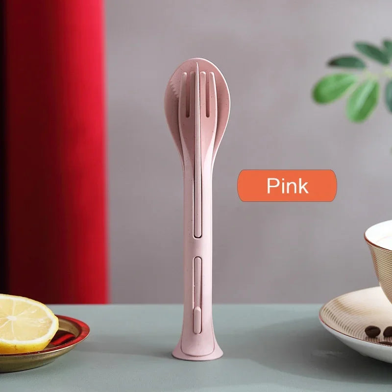 Pink kitchen kawaii utensils on a table with a lemon and plant in the background