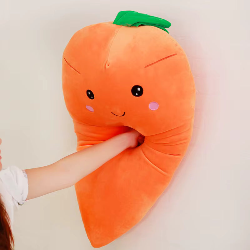 Kawaii plush carrot pillow with a face held by a person against a plain background