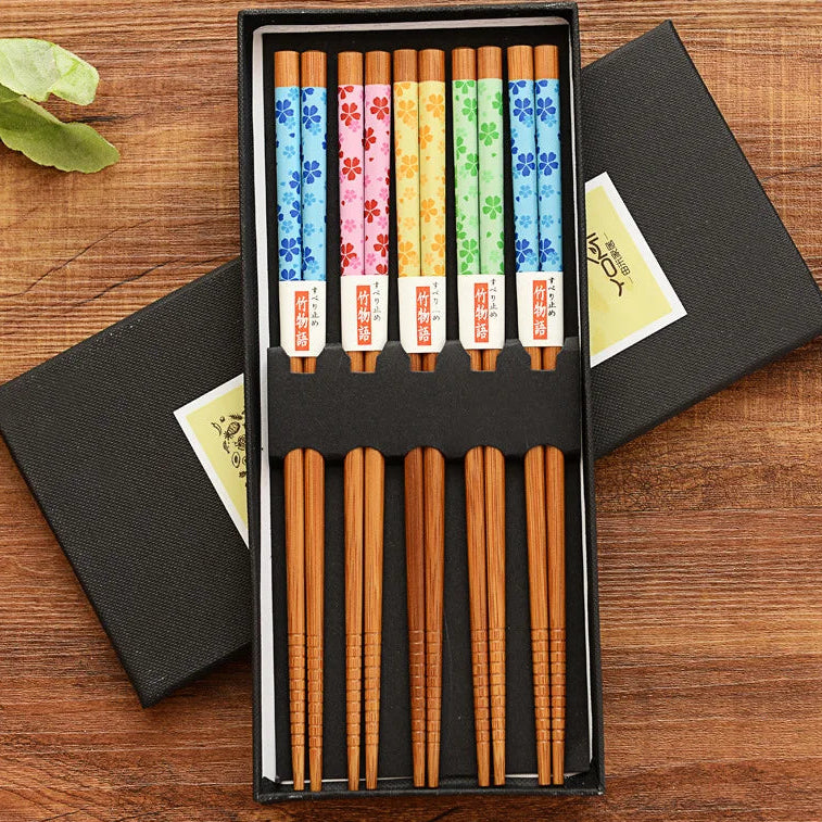 A set of five kawaii chopsticks on a wooden table