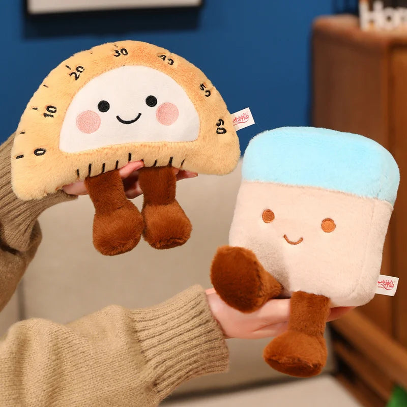 Two kawaii plush toys resembling a cookie and a character with a blue hat held by a person.