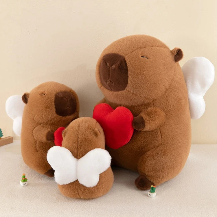 Two brown kawaii plush animals with white wings and red hearts on a beige background