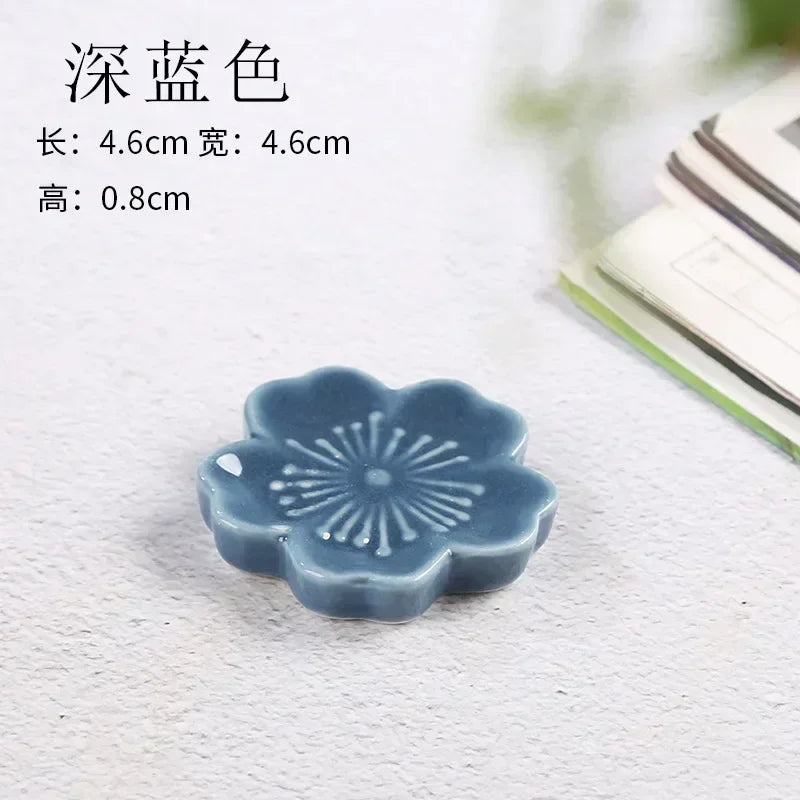 A blue floral shaped kawaii chopstick holder sitting on a table