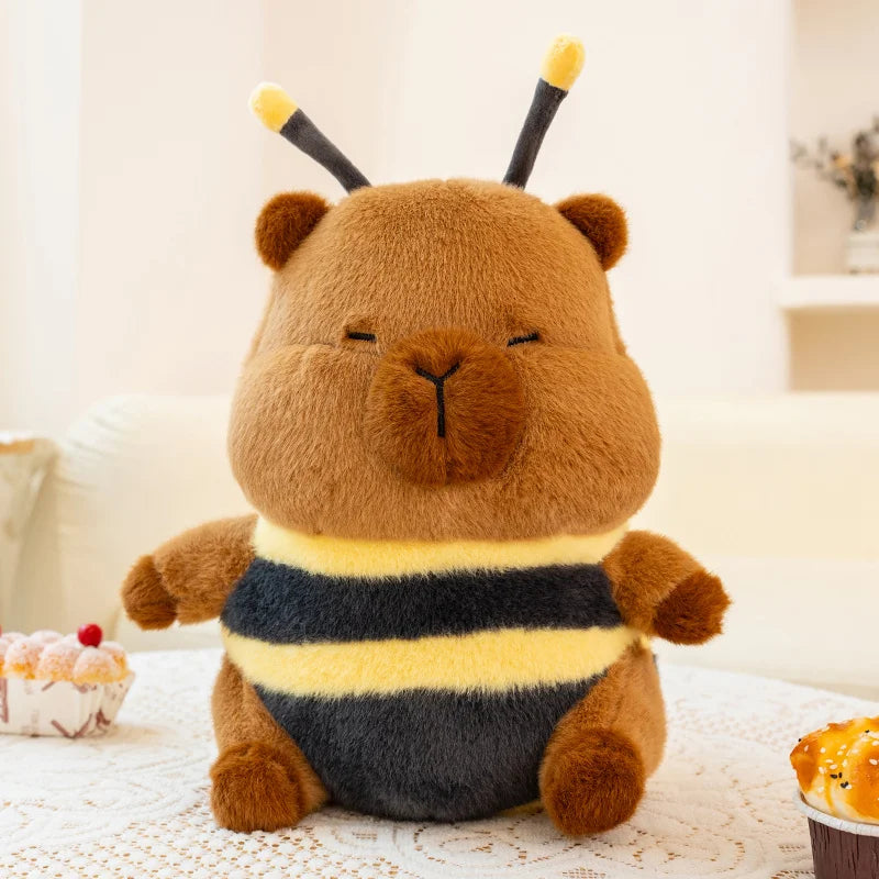 Kawaii plush toy bear dressed as a bee on a light-colored surface with a blurred background