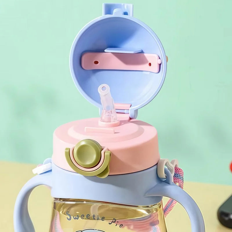 Kawaii cup with pink and blue lid on a light green background