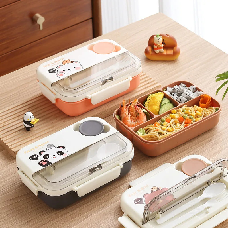 Three kawaii bento boxes with cartoon designs on a wooden table.