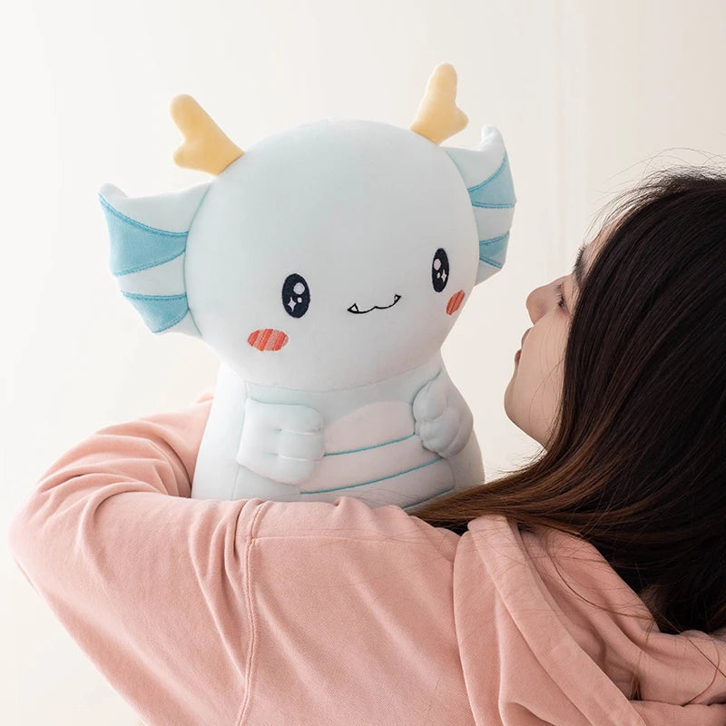 Person holding a cute kawaii  plush axolotl toy against a light background